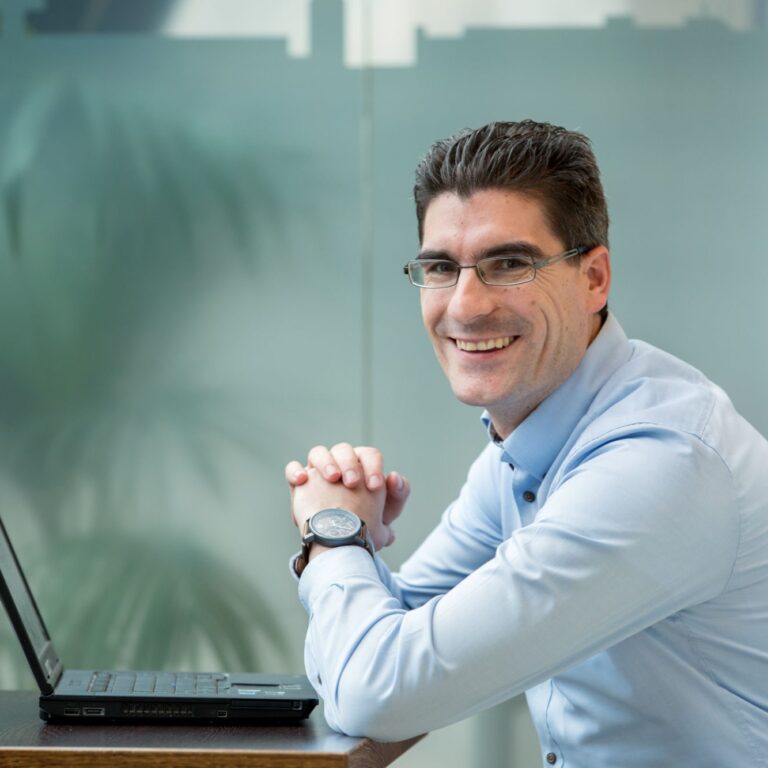 Wilbur Damen zit achter een laptop.